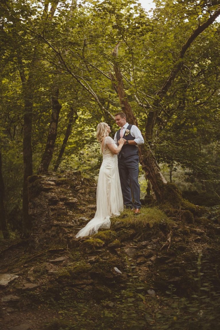 bride and groom in the forest looking at one another portrait