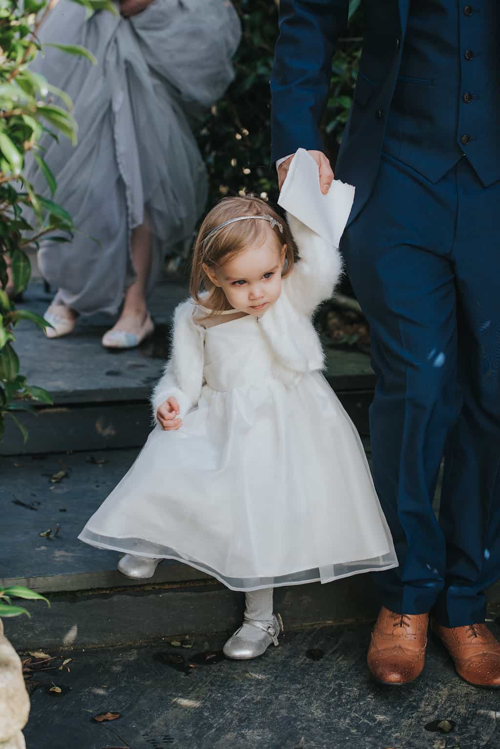real elopement bride and groom's daughter in ivory dress and fluffy shrug