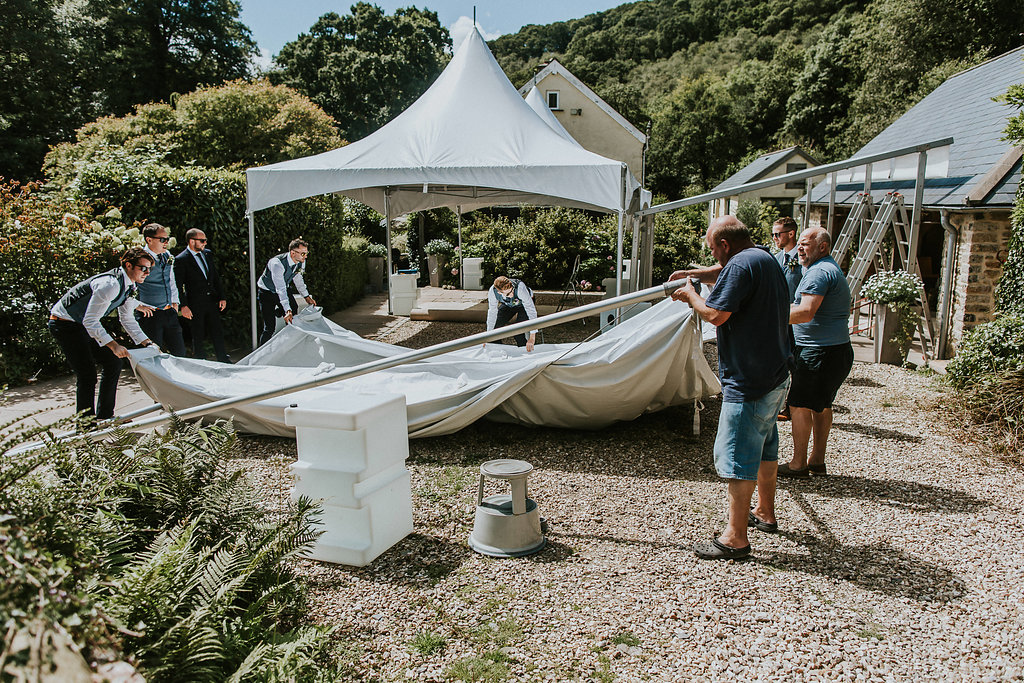 wedding planning problem solved ushers taking down wet weather canopies