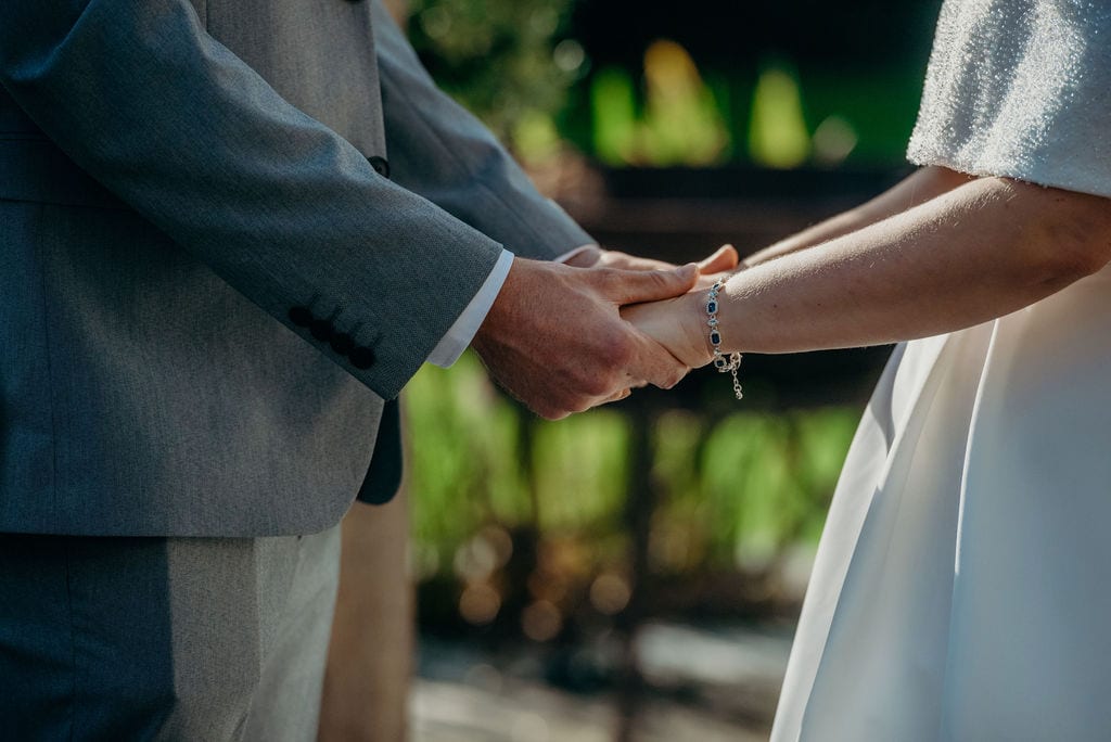 bride & groom holding hands