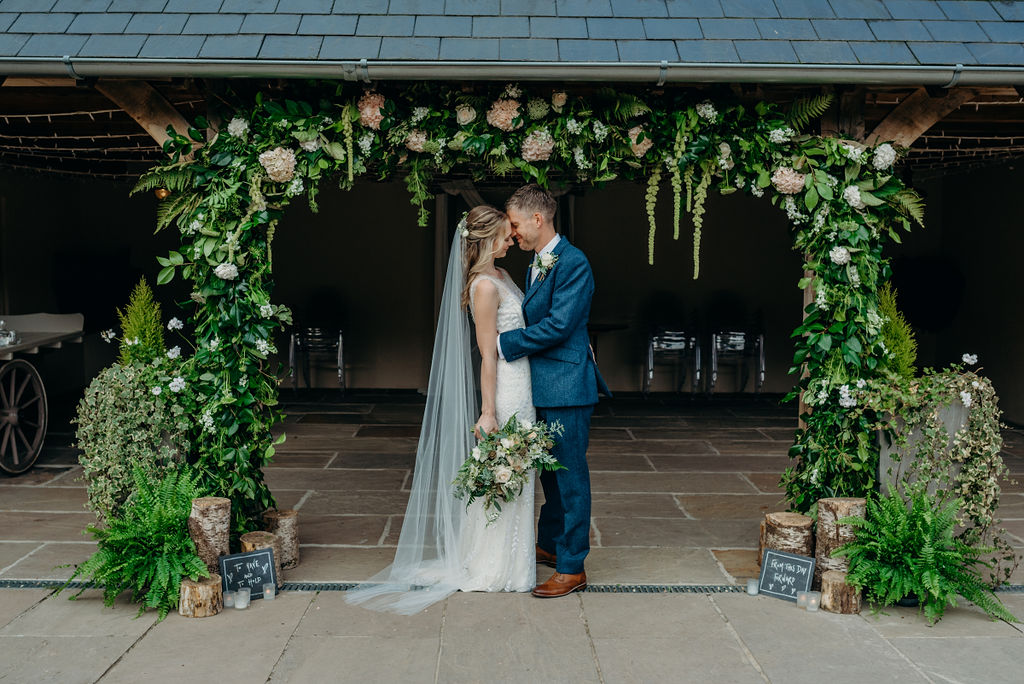 bride groom Ever After wedding barn floral arch