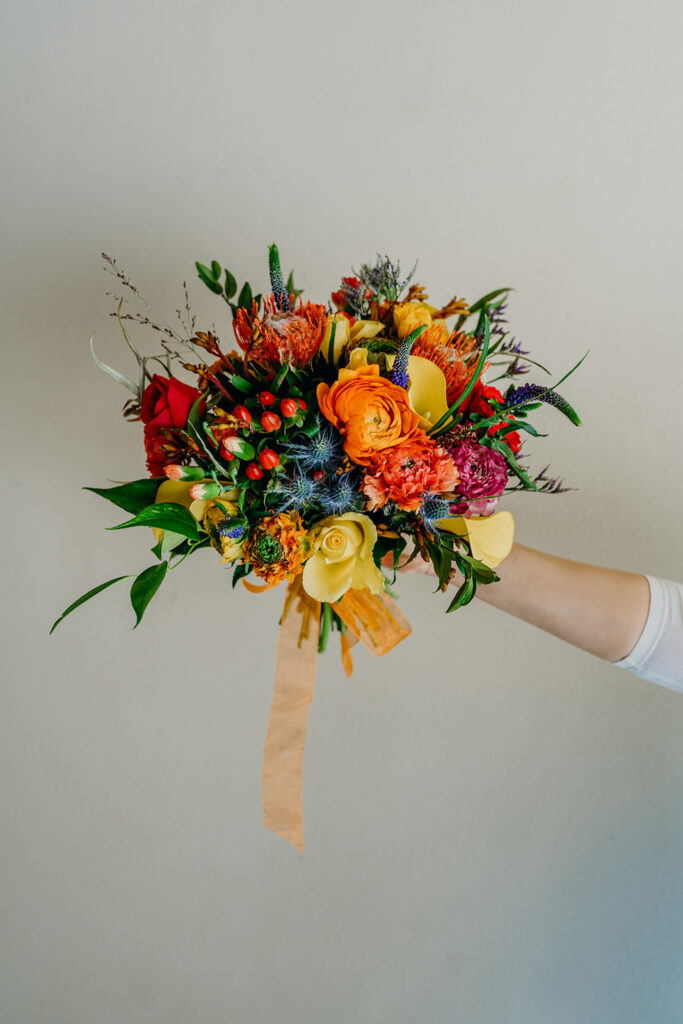 bright coloured wedding bouquet held out