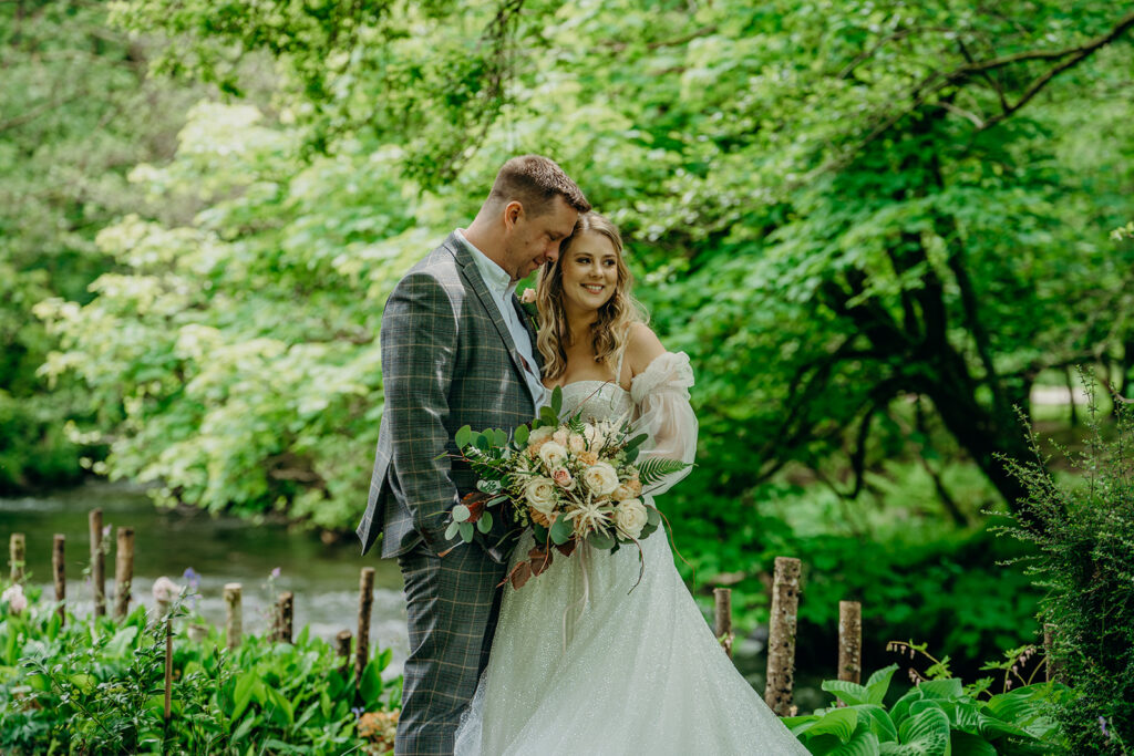 bride and groom by banks of river 2025 elopement dates