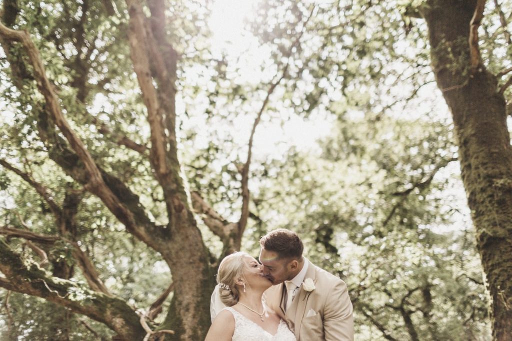 bride and groom woodland wedding kissing 