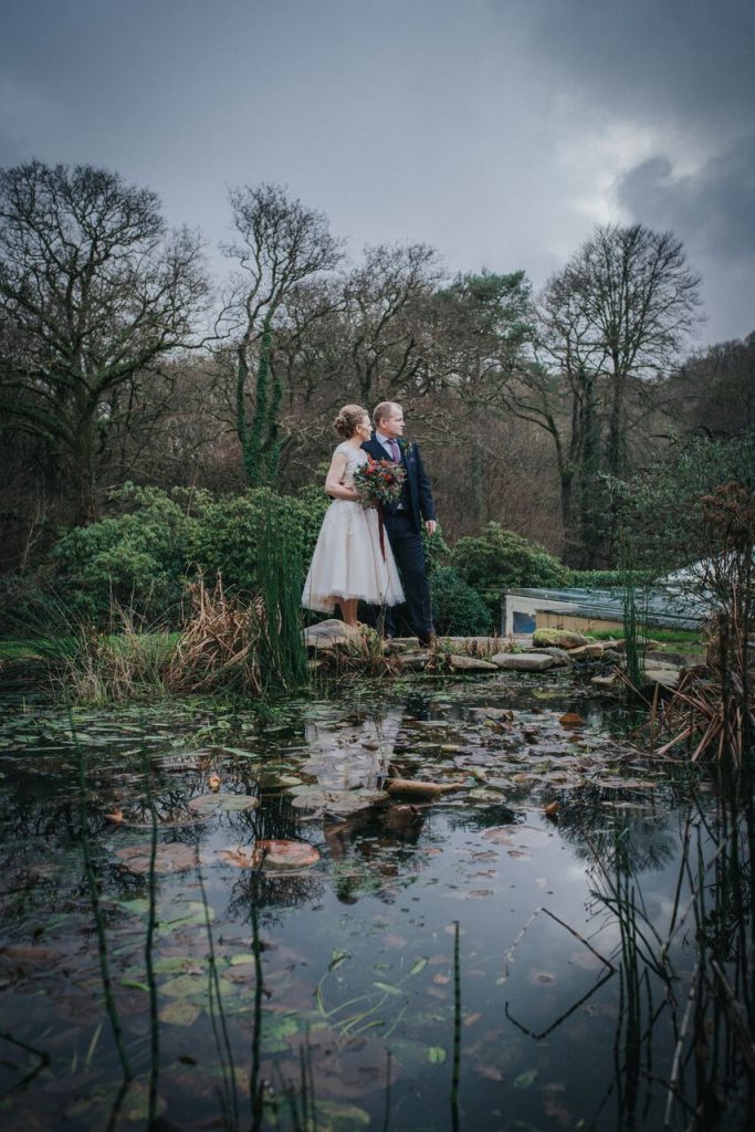 bride and groom by ponds in winter at ever after
