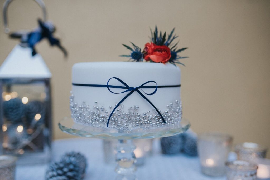 winter wedding cake styled with candles