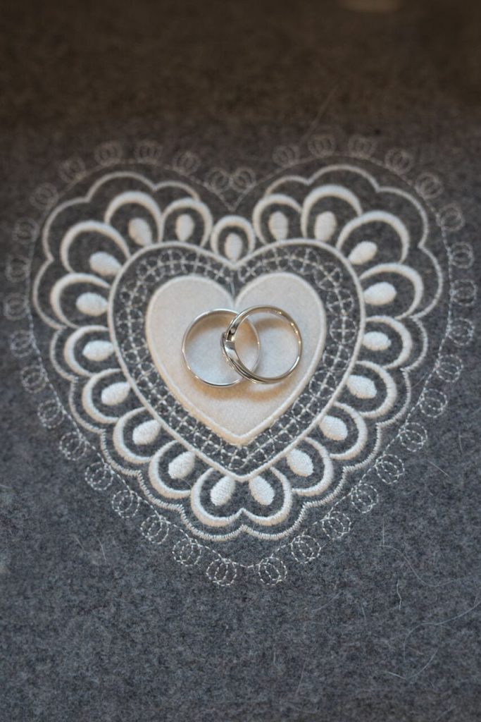 wedding rings centred on an ivory embroidered heart