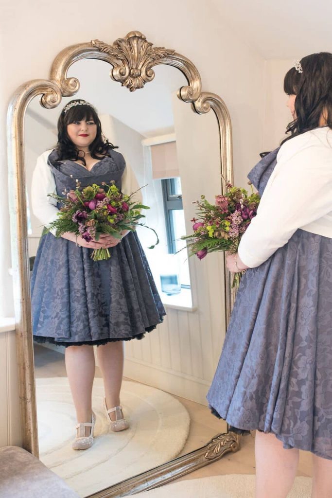 pretty in purple real elopement bride in mirror