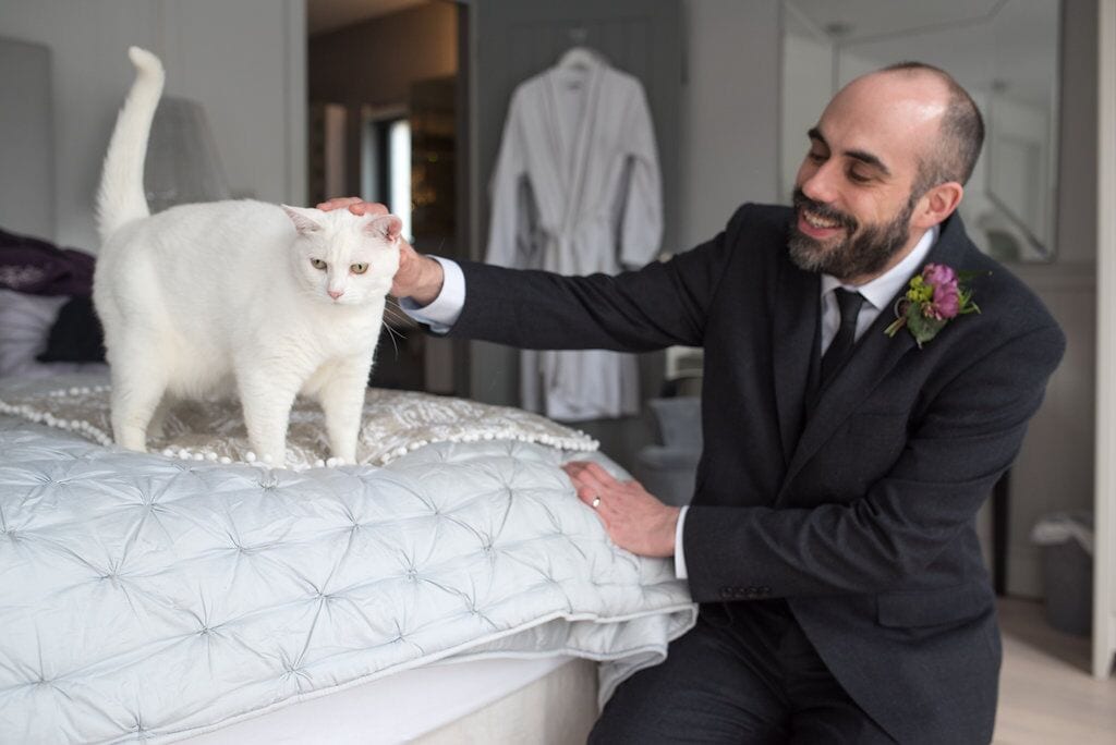 groom and his white cat