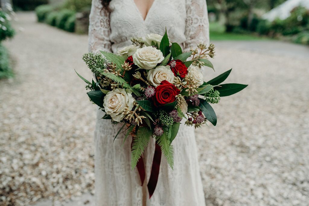 bridal bouquet against wedding dress supreme styling blog