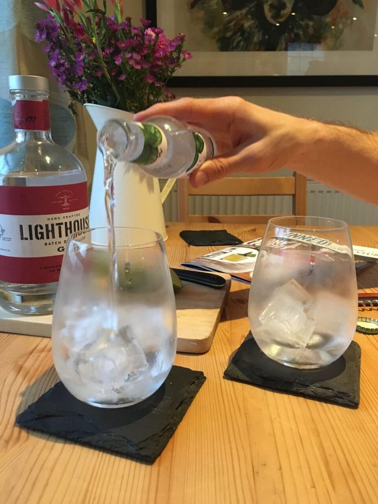 lighthouse gin pouring tonic into glasses