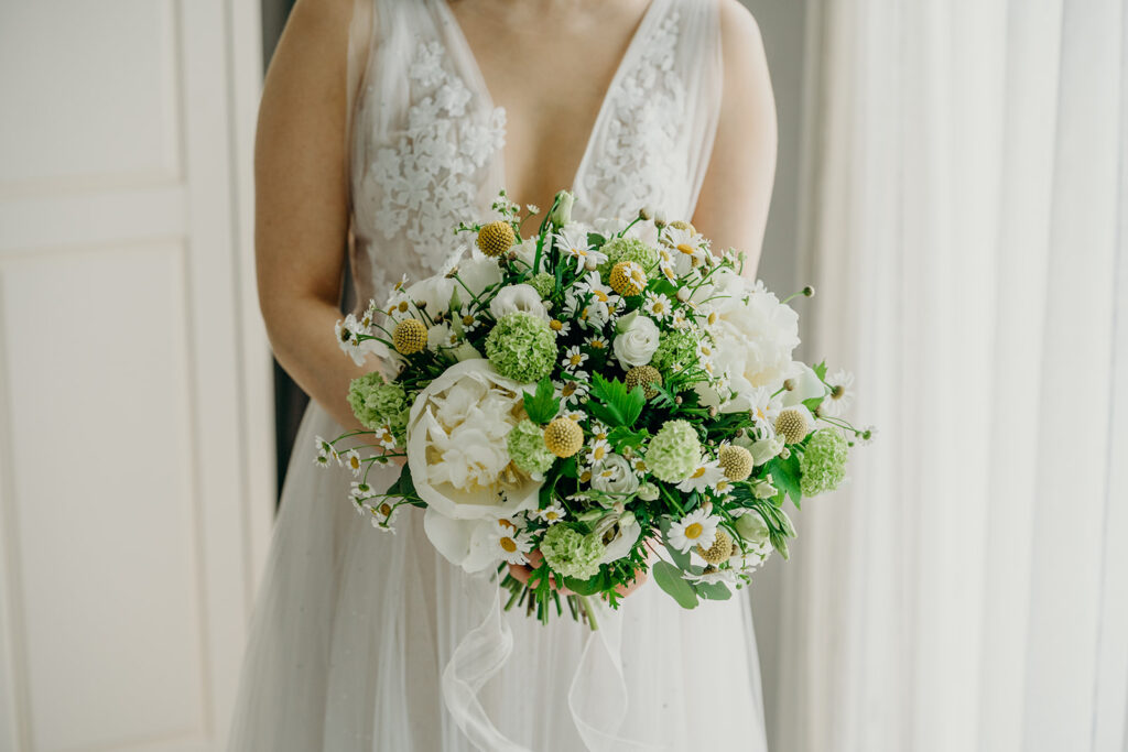 close up of bridal bouquet with white peonies and viburnum opulus