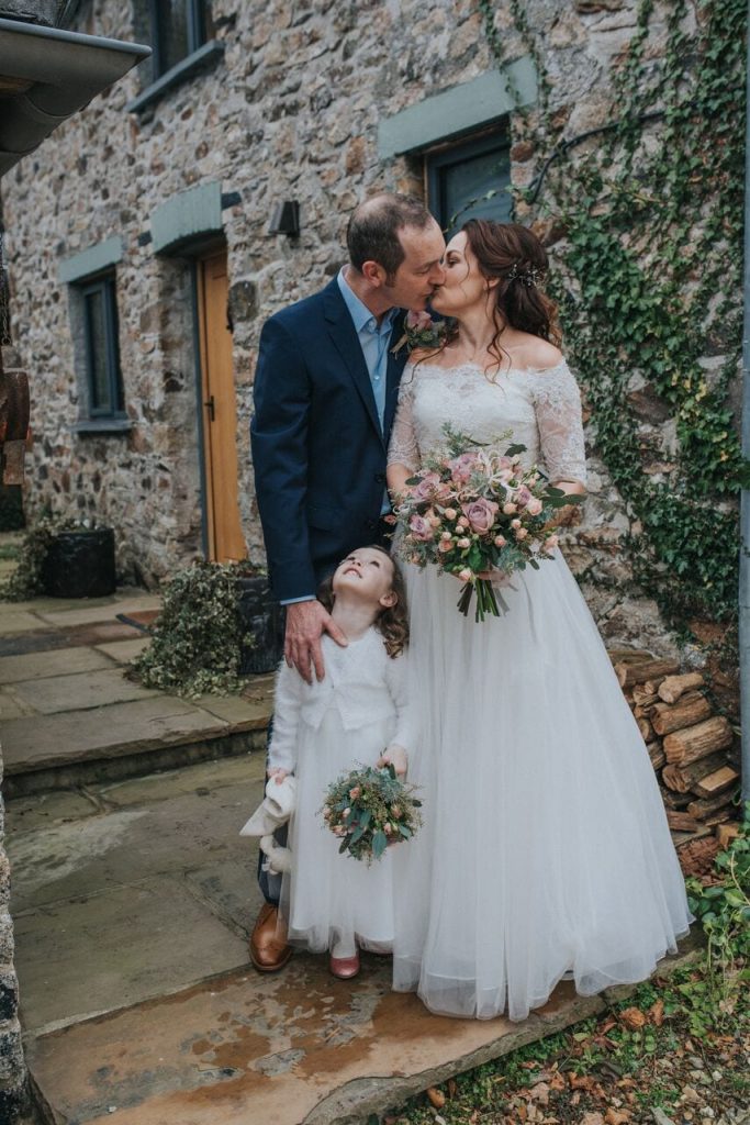bride and groom and daughter at winter elopement wedding