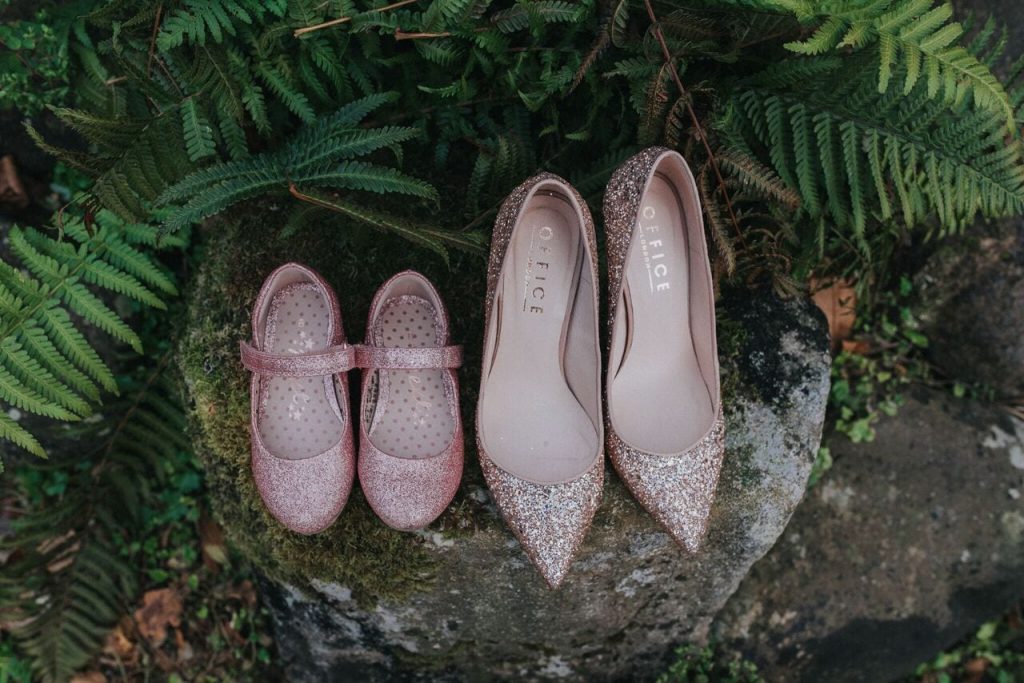 mother and daughter pink sparkly shoes on a log