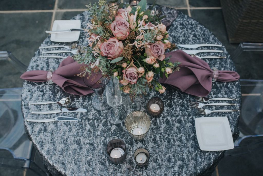 sparkly silver tablecloth with purple napkins