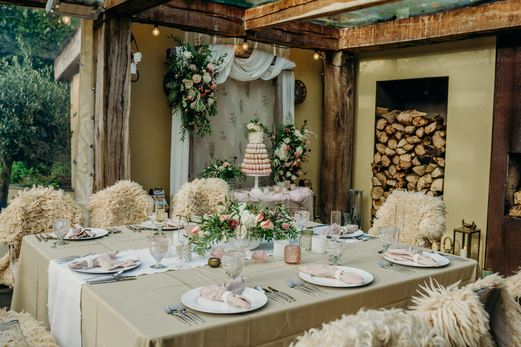 rustic elopement wedding breakfast set up on Dartmoor in green and pink with flowers and tier macaron wedding cake 