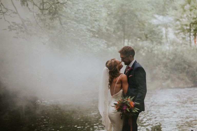bride and groom by river